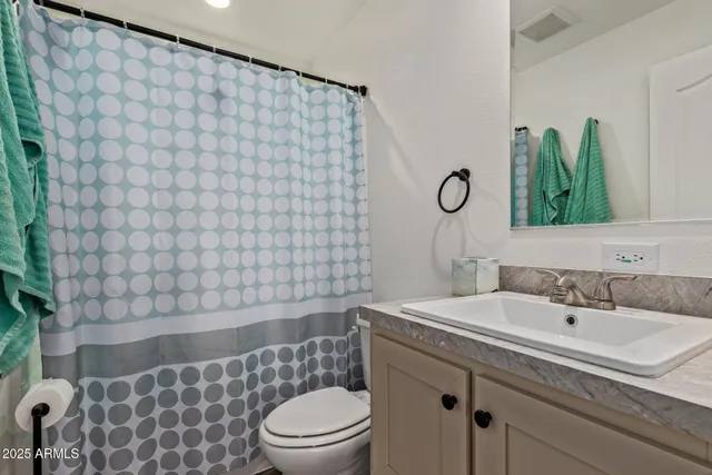 a bedroom with a bed and a refrigerator