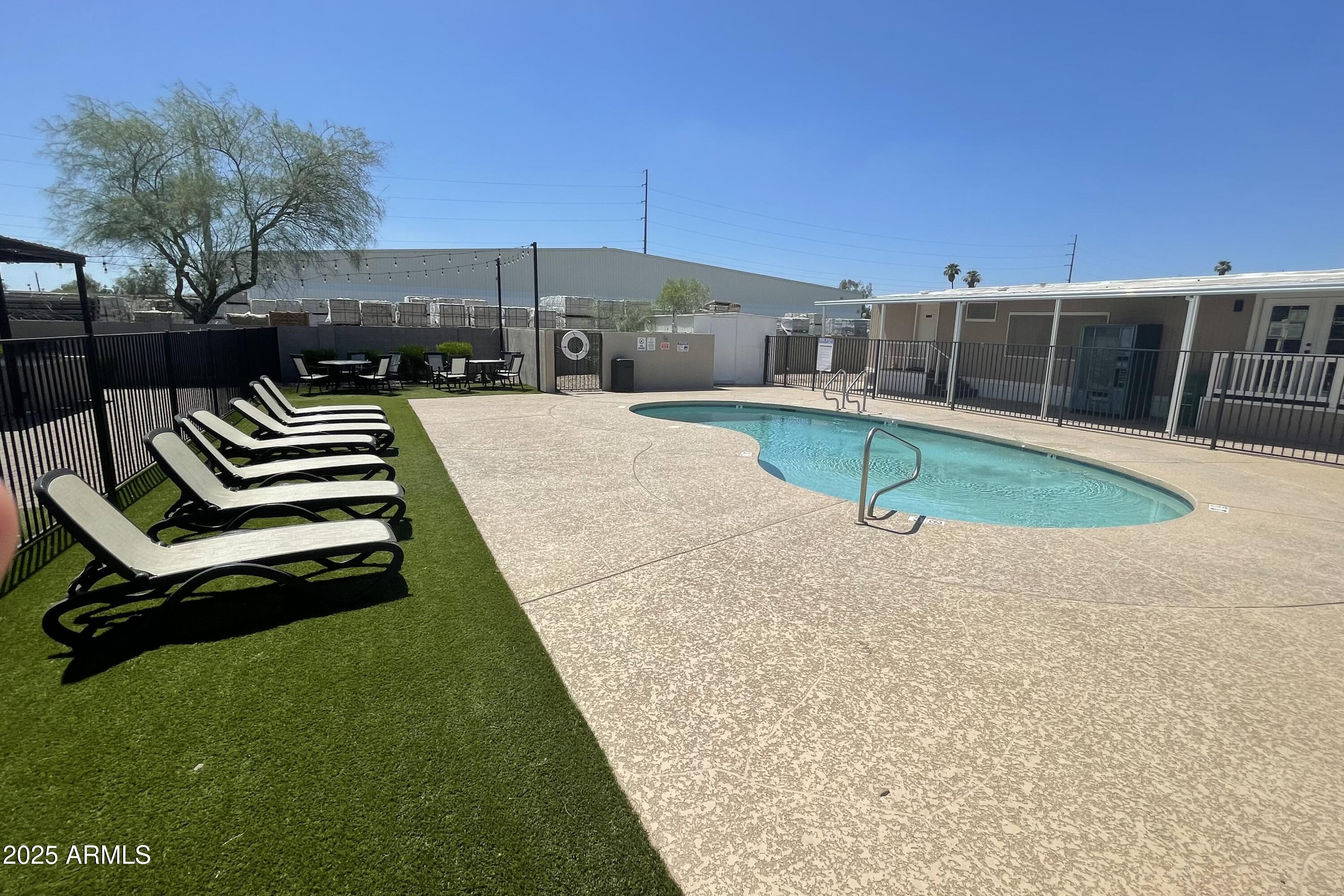 501 East Ray Road, Unit 201 Chandler, AZ 85225 - Photo 22 of 28 a swimming pool with outdoor seating and yard