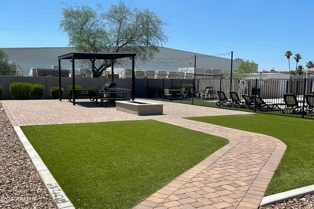 a swimming pool with outdoor seating and yard