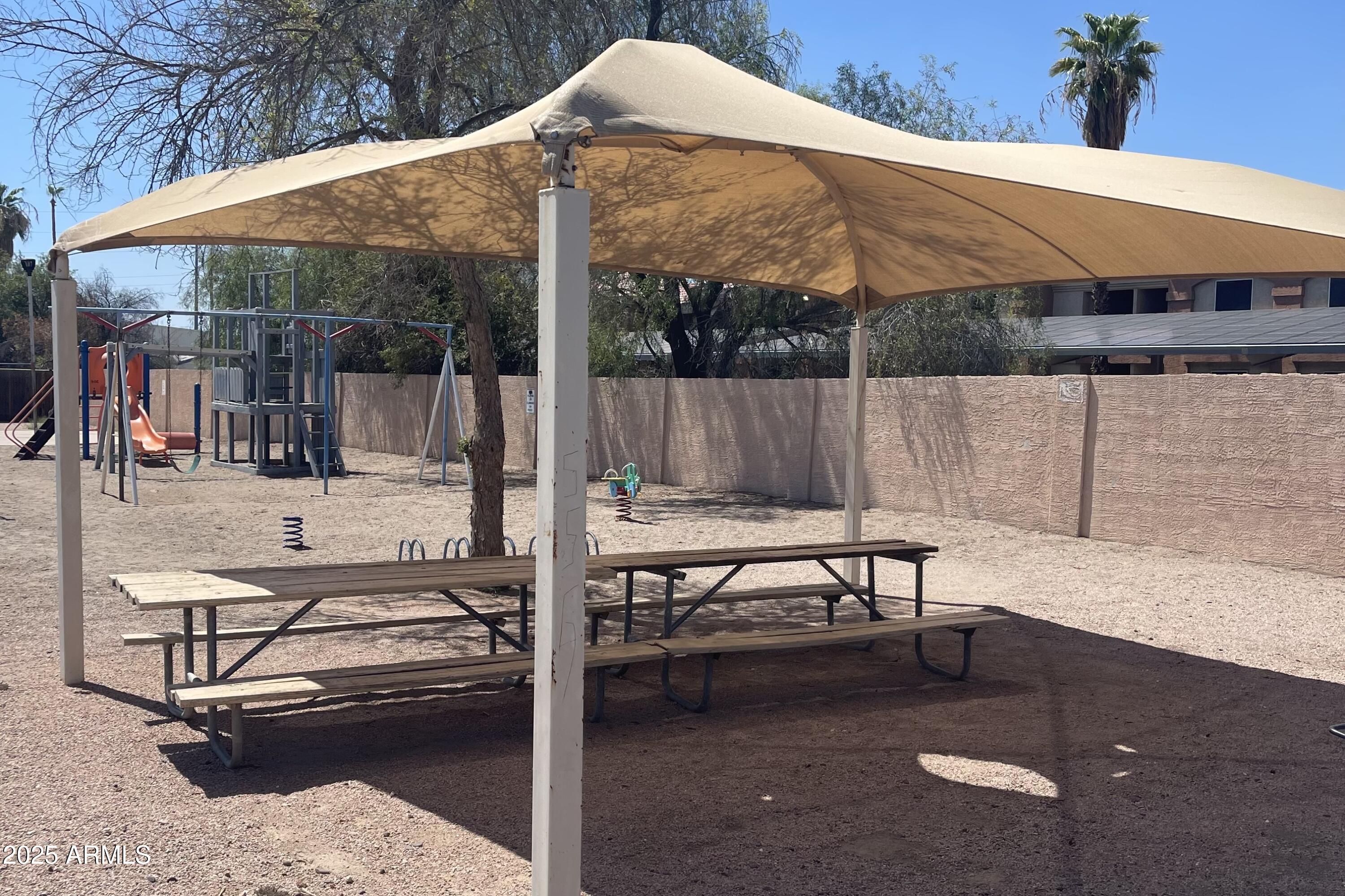 501 East Ray Road, Unit 201 Chandler, AZ 85225 - Photo 25 of 28 a backyard of a house with table and chairs