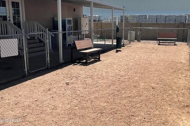 a backyard of a house with table and chairs
