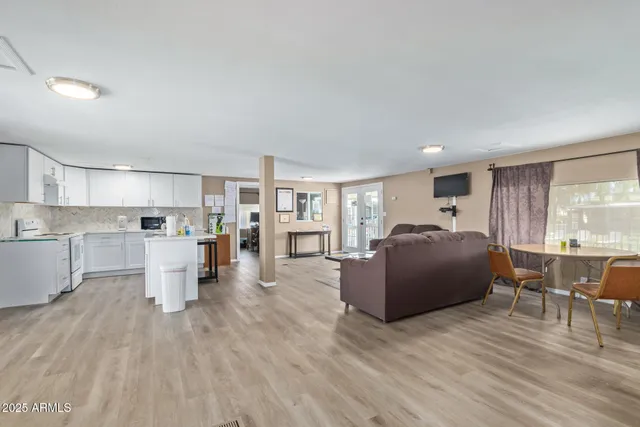 a backyard of a house with barbeque oven and outdoor seating