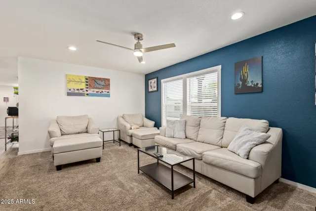 a living room with furniture and a large window