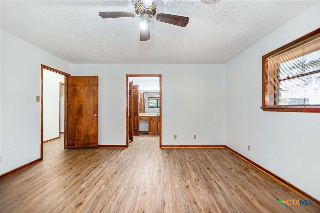 181 Pecan Street Port Lavaca, TX 77979 - Photo 18 of 34 an empty room with wooden floor and windows