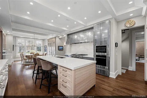 a kitchen with a sink appliances and wooden floor