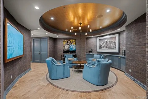 a living room with furniture and a chandelier