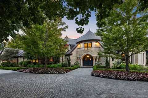 a view of an entrance to house with yard and green space