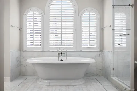 a bath tub sitting in a bathroom next to a window