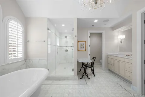a bathroom with a granite countertop sink a toilet and bathtub