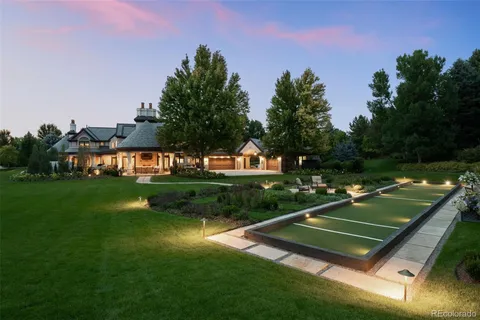 a view of a tennis ground with large trees
