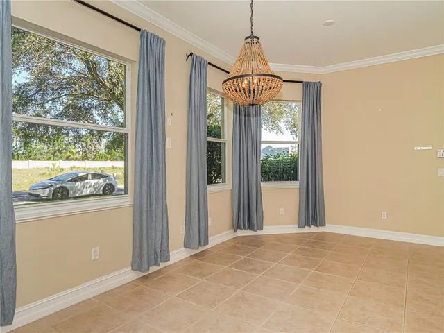 an empty room with a window and a ceiling fan