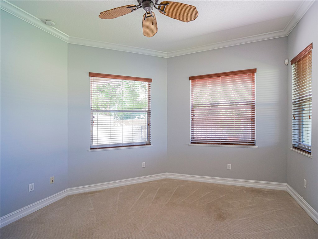 1965 Bridgepointe Circle, Unit 84 Vero Beach, FL 32967 - Photo 17 of 33 an empty room with a window and a ceiling fan