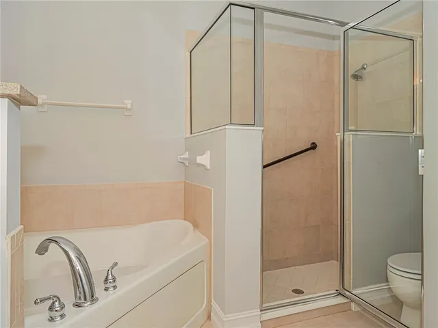 a front view of a house with a garden and plants