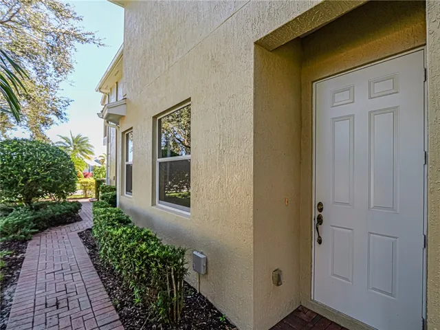 a view of a hallway with a table and a clock on walls