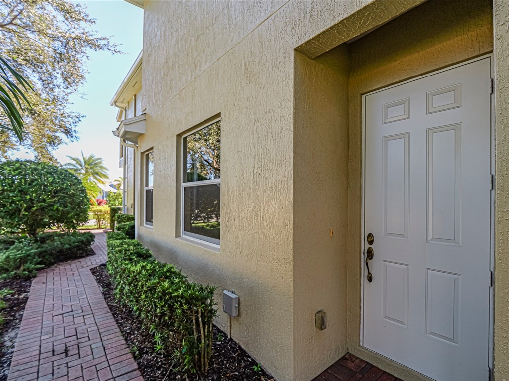 1965 Bridgepointe Circle, Unit 84 Vero Beach, FL 32967 - Photo 5 of 33 a front view of a house with a yard