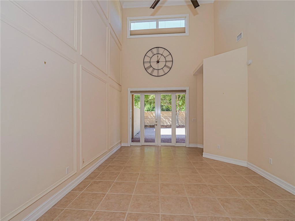 1965 Bridgepointe Circle, Unit 84 Vero Beach, FL 32967 - Photo 7 of 33 a view of a hallway with a table and a clock on walls