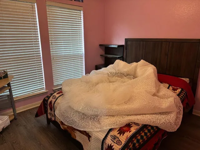 a bed sitting in a bedroom next to a window