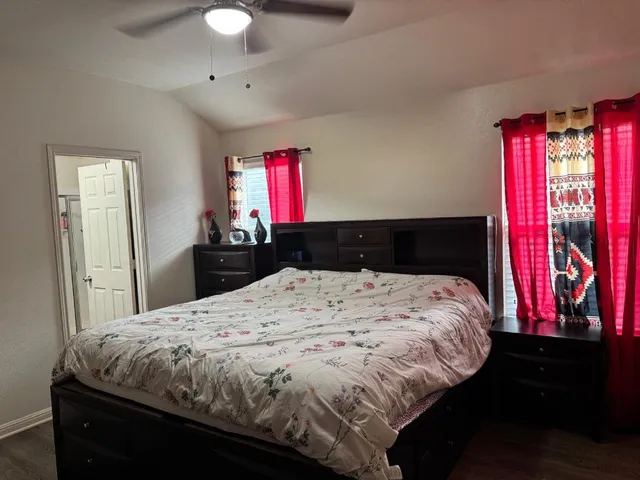 a bedroom with a bed and a chandelier