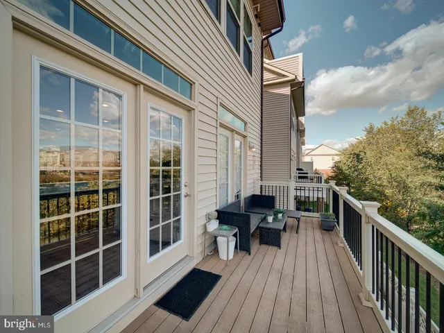 a view of a balcony with chairs and wooden floor