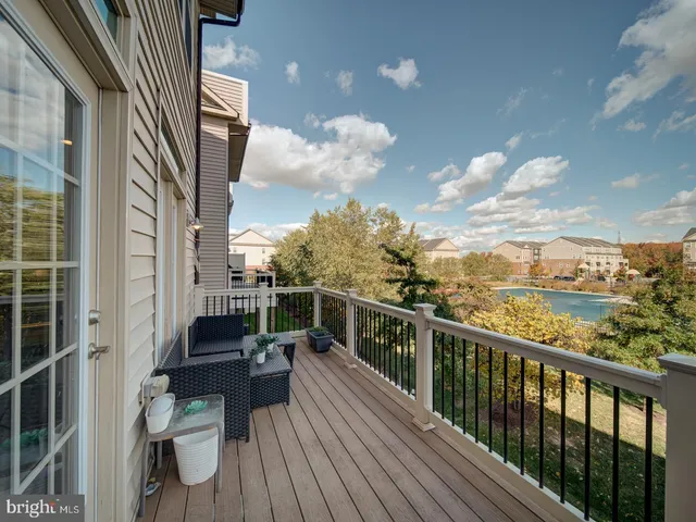 a view of a balcony with couches and wooden floor
