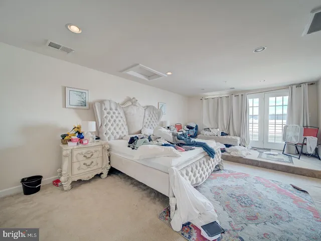 a bed room with bed and a window