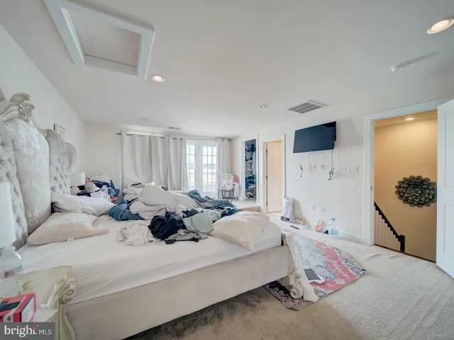 a bedroom with a bed couch and window