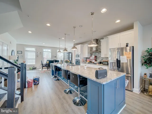 a large kitchen with stainless steel appliances lots of counter top space