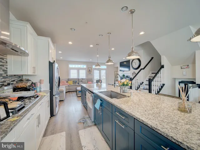 a kitchen with counter top space a sink stainless steel appliances and cabinets