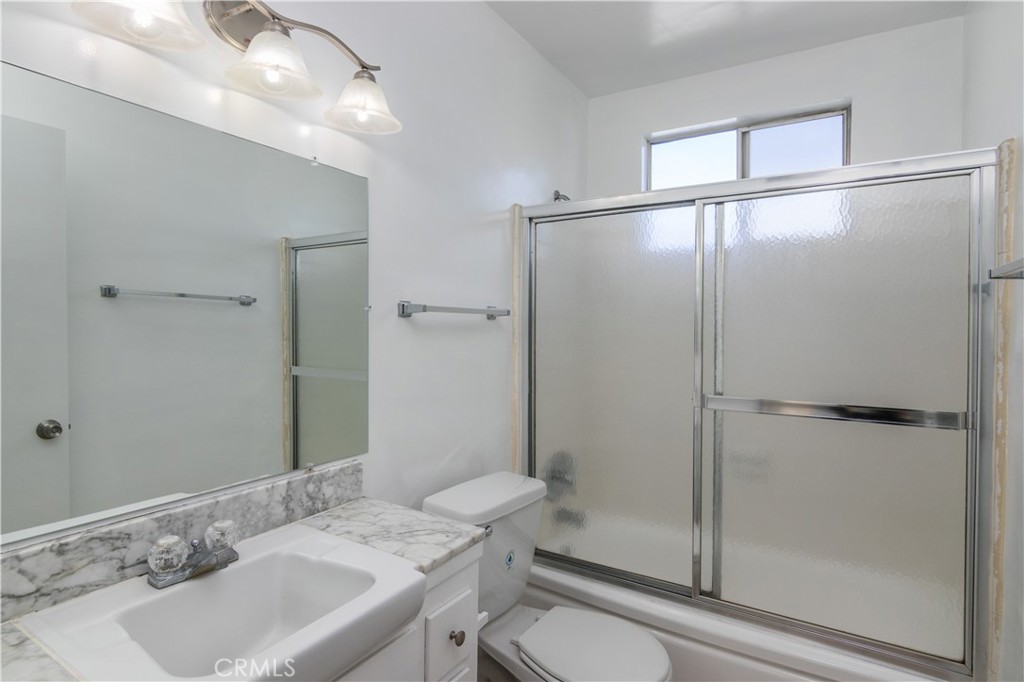 3662 Keystone Avenue, Unit 7 Los Angeles, CA 90034 - Photo 11 of 14 a bathroom with a sink toilet and shower