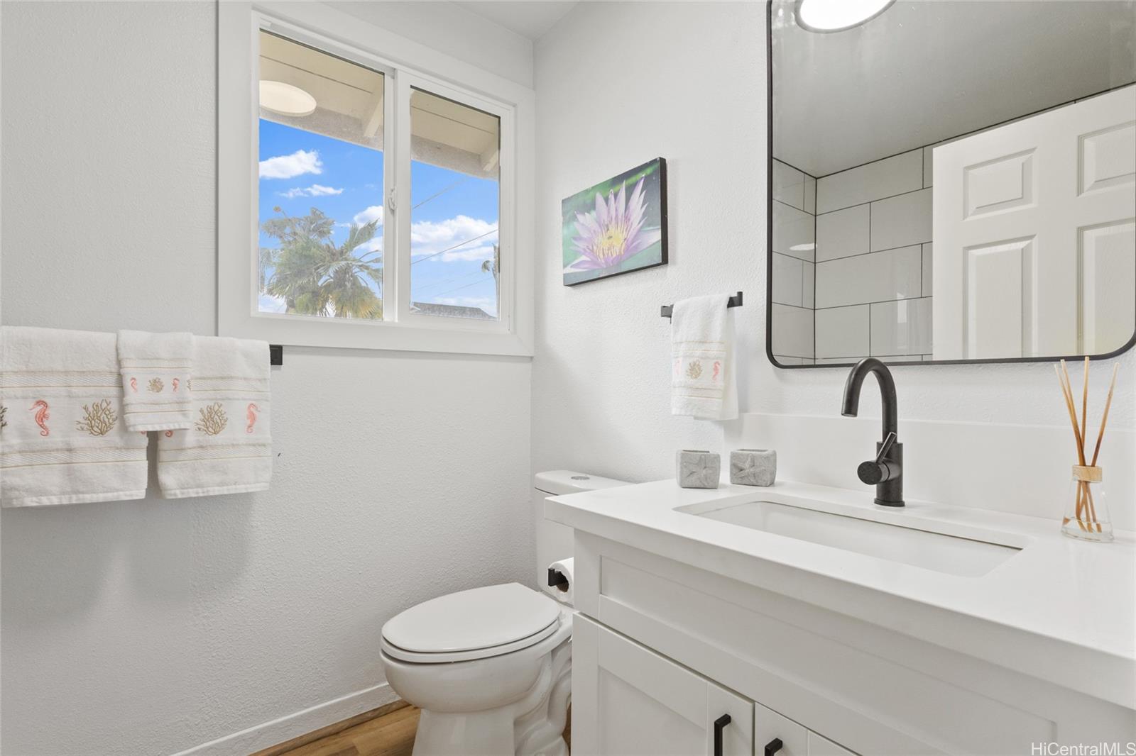 91-433 Ewa Beach Road Ewa Beach, HI 96706 - Photo 12 of 22 a bathroom with a toilet sink and mirror