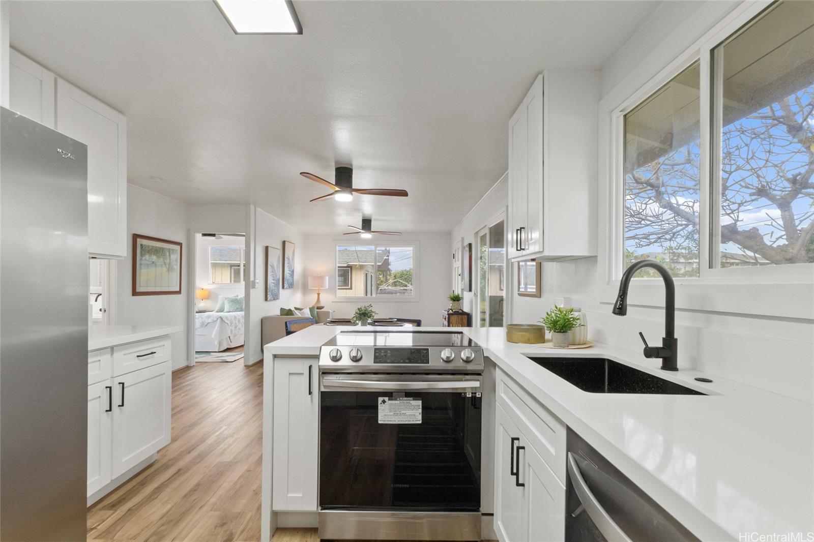 91-433 Ewa Beach Road Ewa Beach, HI 96706 - Photo 13 of 22 a kitchen with stainless steel appliances a sink stove and cabinets