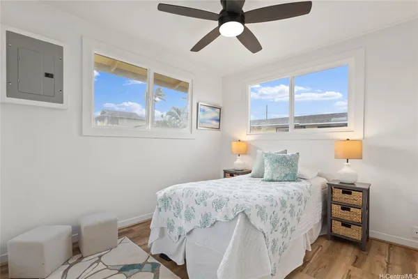 a bedroom with a bed and a painting on the wall