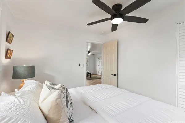 a bedroom with a bed and a chandelier