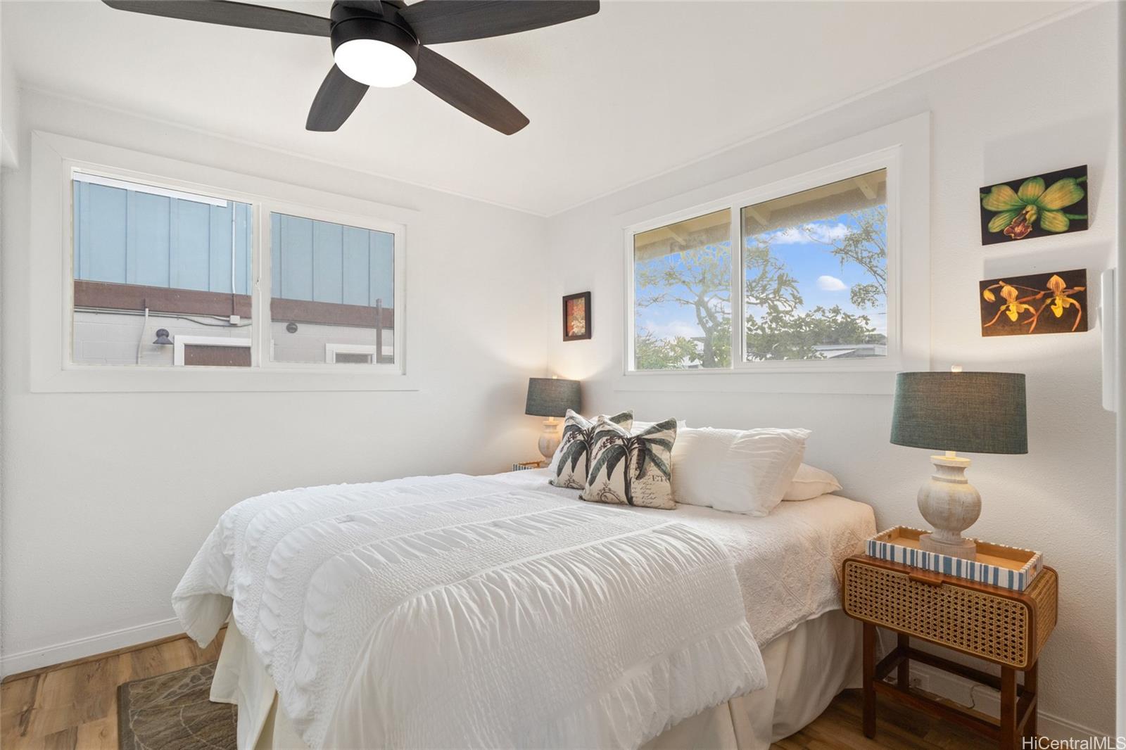91-433 Ewa Beach Road Ewa Beach, HI 96706 - Photo 19 of 22 a bedroom with a bed and a painting on the wall