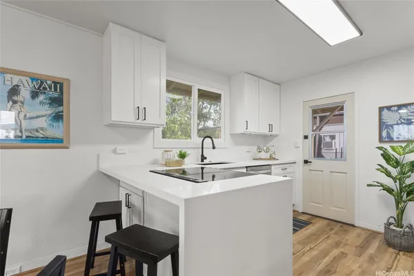 a kitchen with a sink cabinets and window