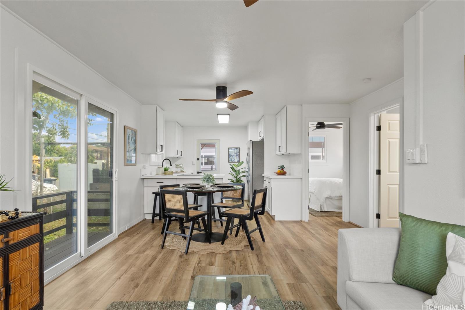 91-433 Ewa Beach Road Ewa Beach, HI 96706 - Photo 3 of 22 a view of a dining room with furniture and wooden floor