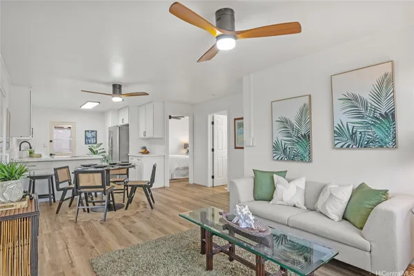 a living room with furniture and wooden floor