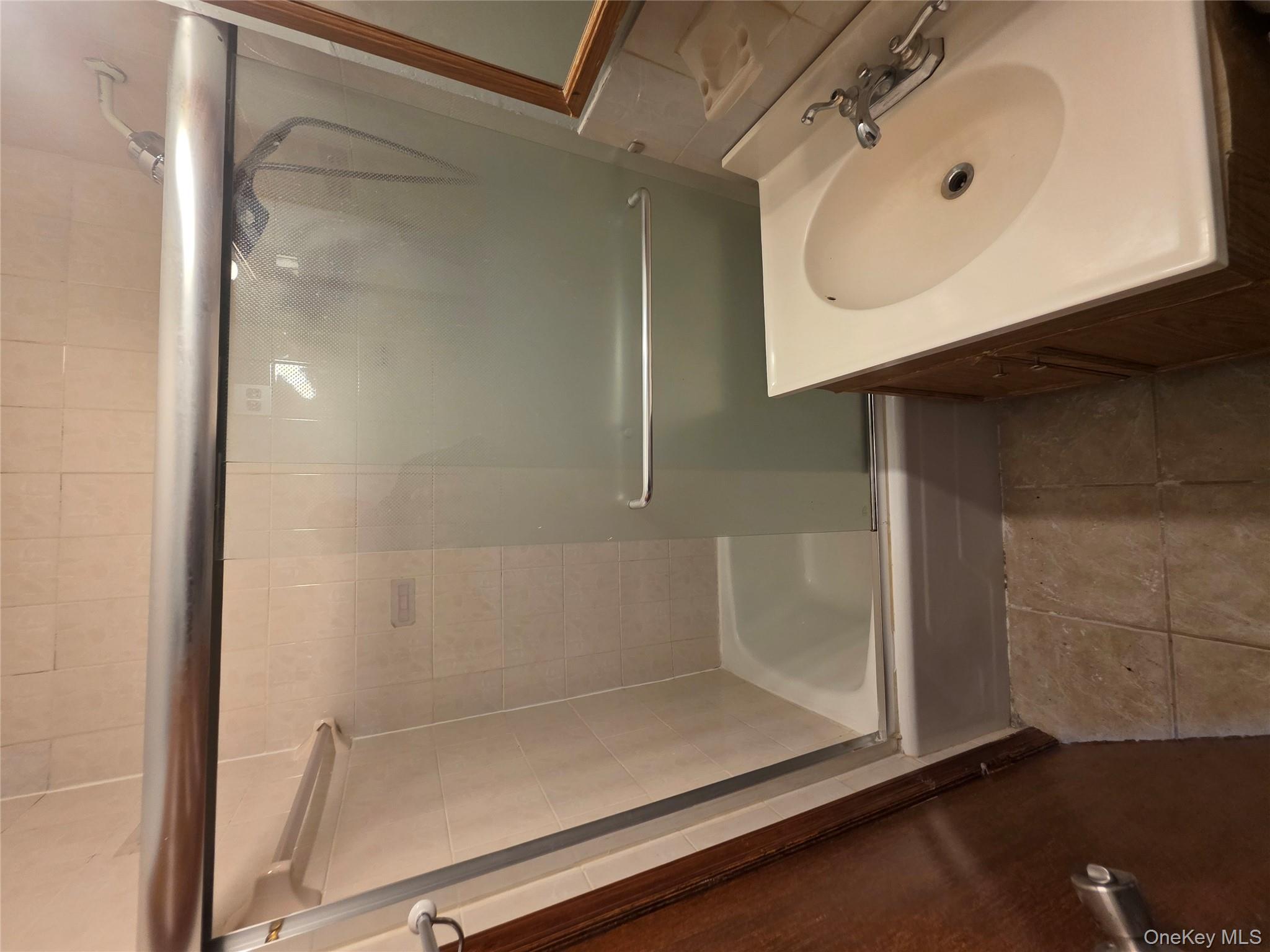 1020 Grand Concourse, Unit 17M Bronx, NY 10451 - Photo 11 of 20 a bathroom with a sink and a shower