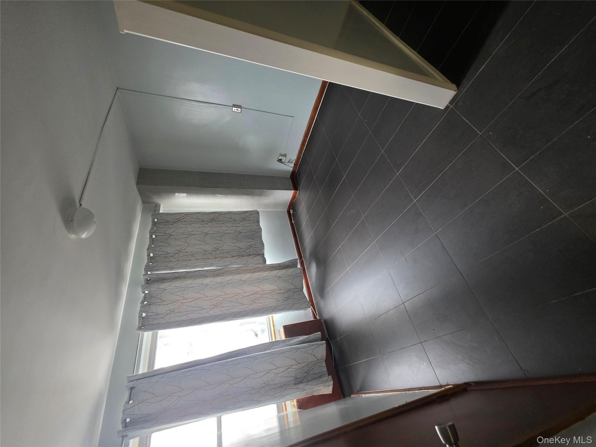 1020 Grand Concourse, Unit 17M Bronx, NY 10451 - Photo 12 of 20 a view of an empty room with wooden floor and a window