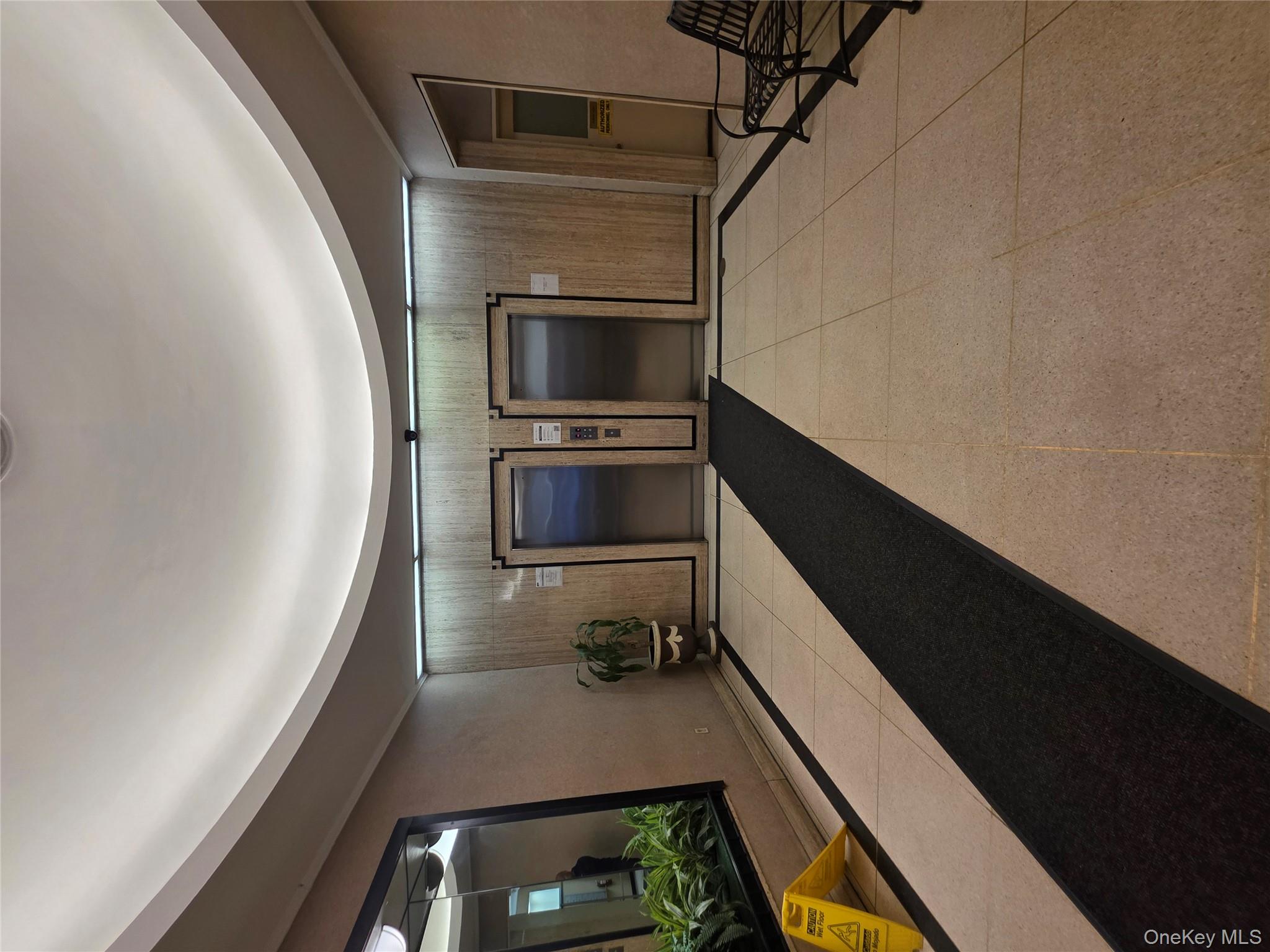 1020 Grand Concourse, Unit 17M Bronx, NY 10451 - Photo 15 of 20 a lobby with a couch and a mirror