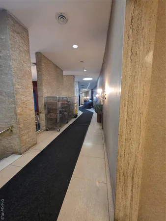 a lobby with furniture and a chandelier