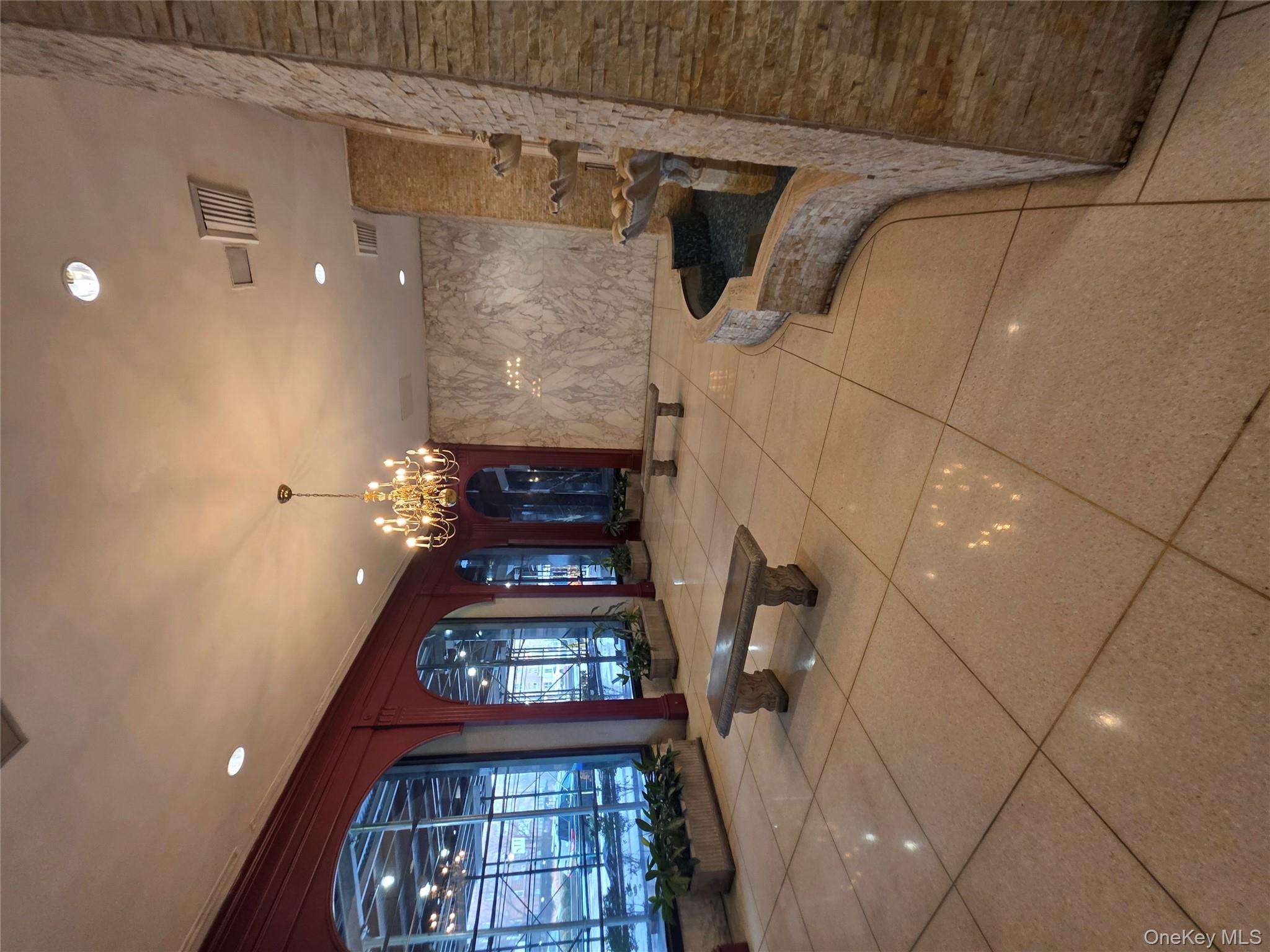 1020 Grand Concourse, Unit 17M Bronx, NY 10451 - Photo 17 of 20 a lobby with furniture and a chandelier