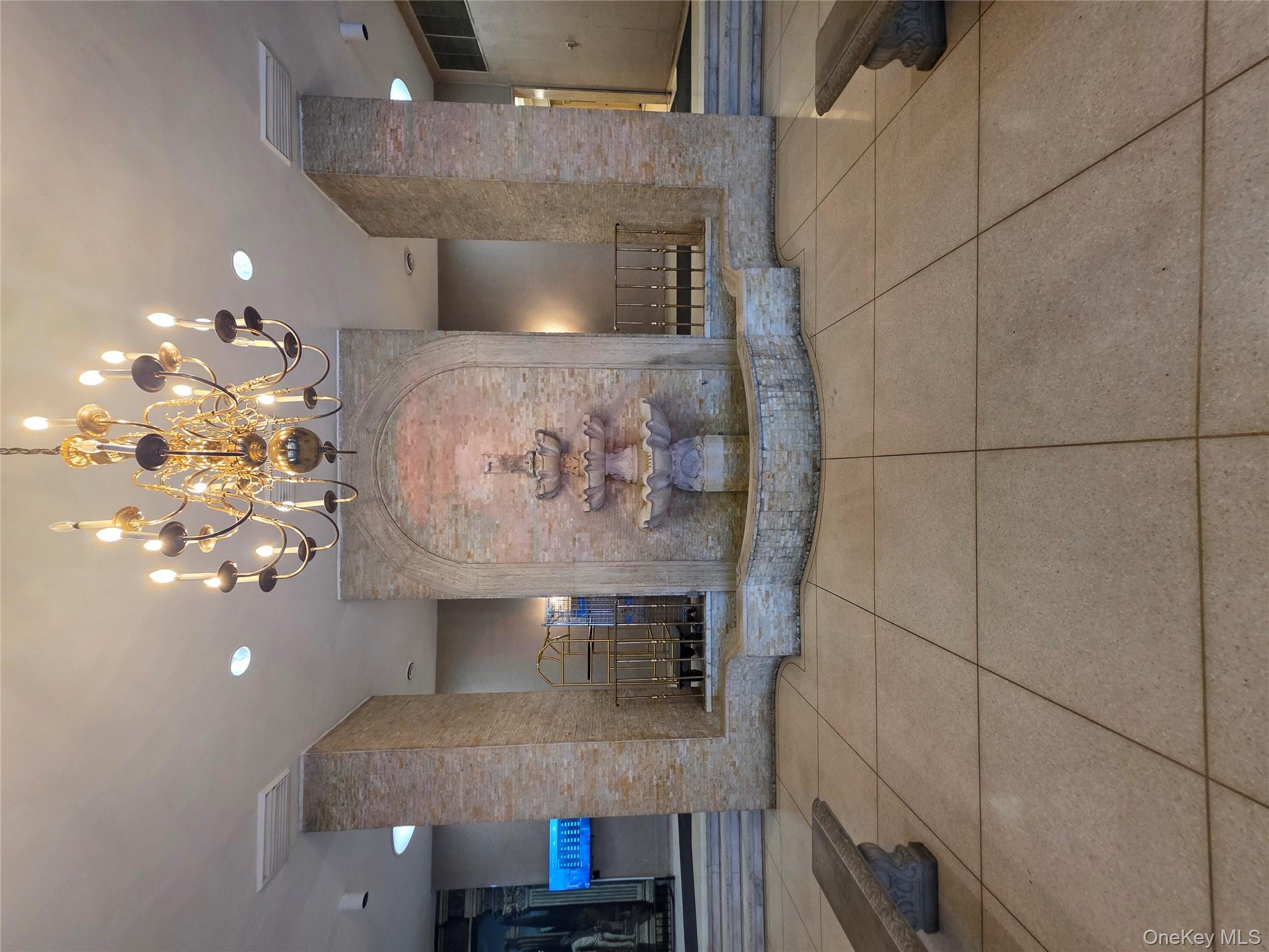 1020 Grand Concourse, Unit 17M Bronx, NY 10451 - Photo 18 of 20 a lobby with a chandelier and dining table