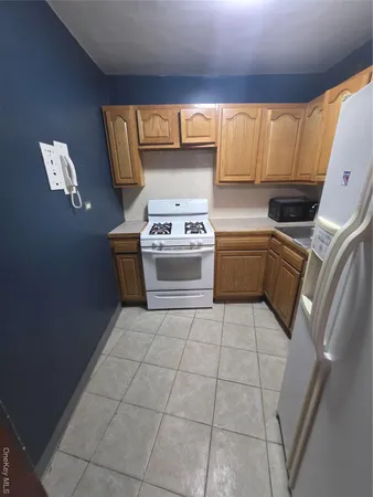 a kitchen with a stove top oven sink and cabinets