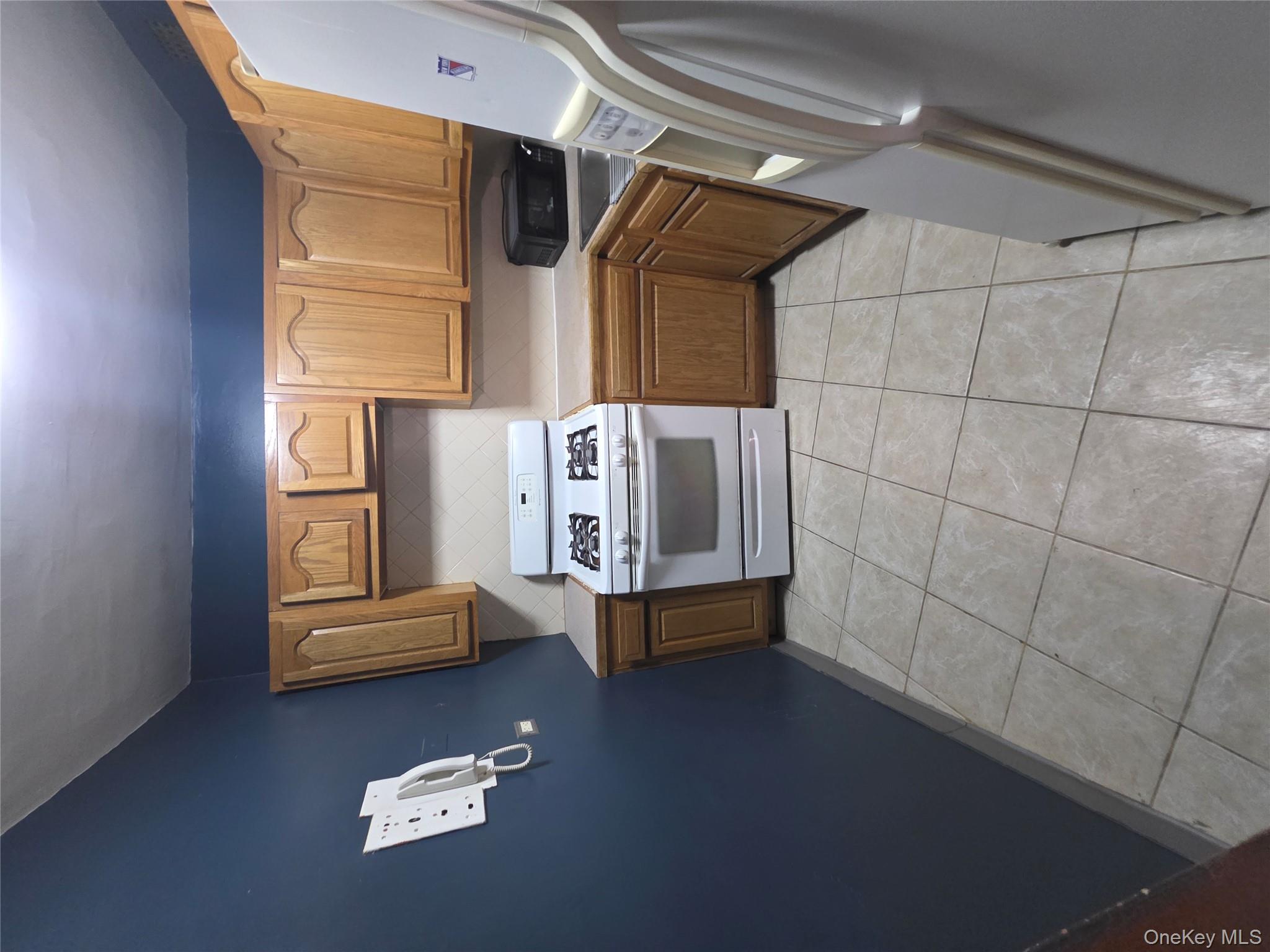 1020 Grand Concourse, Unit 17M Bronx, NY 10451 - Photo 3 of 20 a kitchen with a stove top oven sink and cabinets