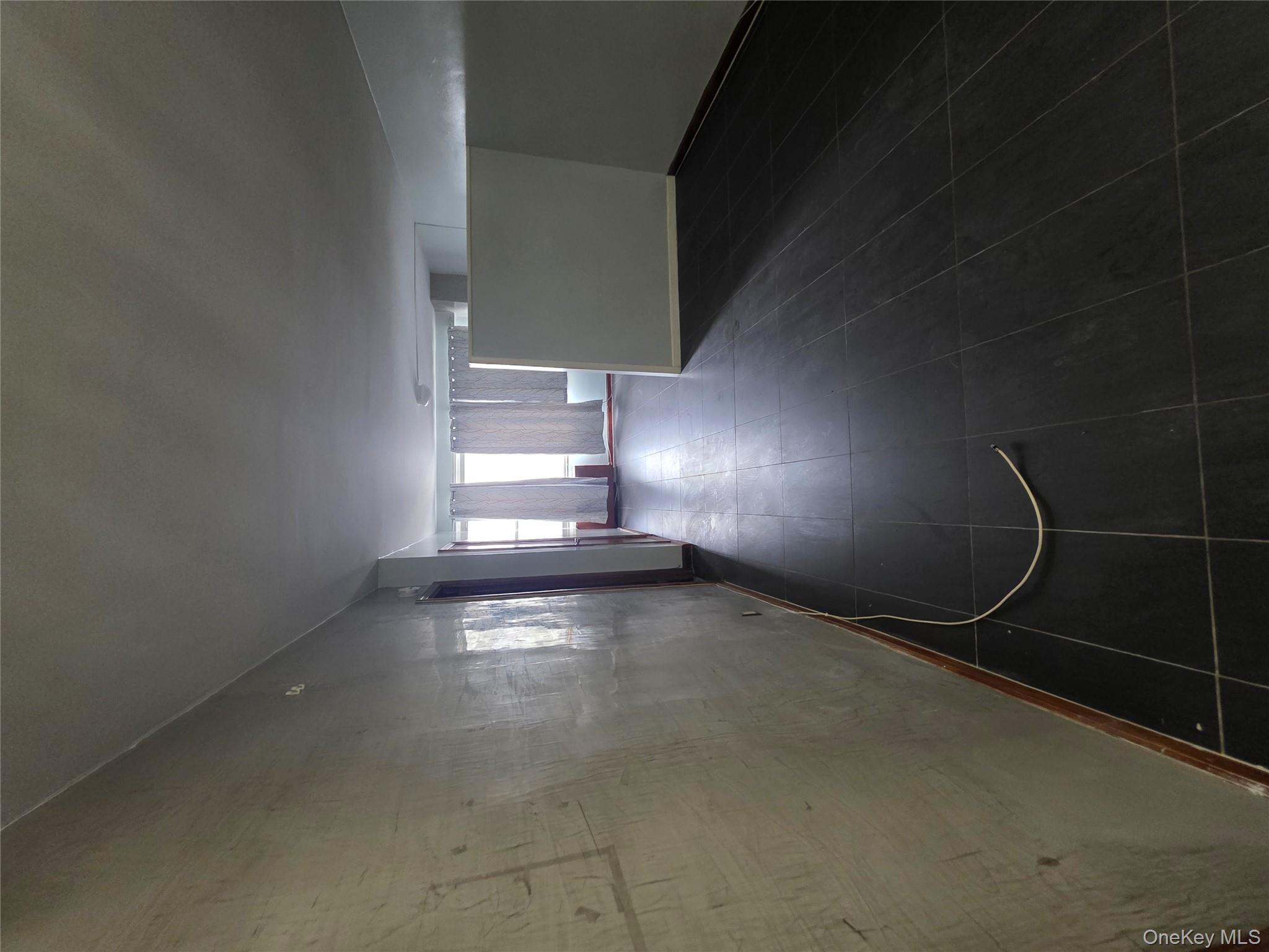 1020 Grand Concourse, Unit 17M Bronx, NY 10451 - Photo 4 of 20 an empty room with wooden floor and windows