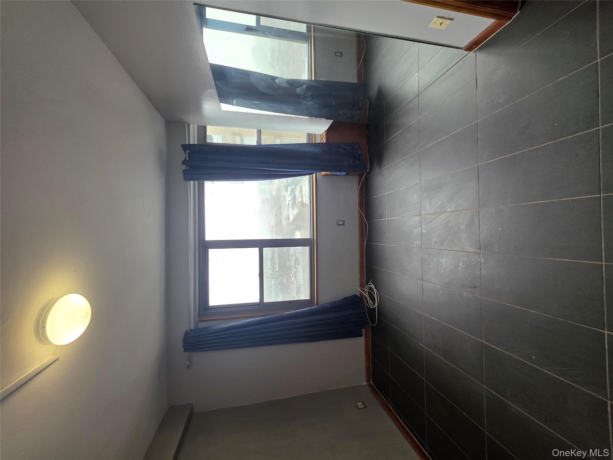 1020 Grand Concourse, Unit 17M Bronx, NY 10451 - Photo 8 of 20 an empty room with windows