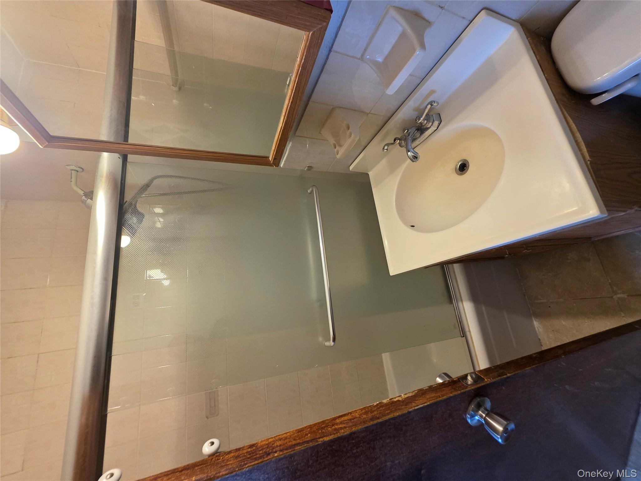 1020 Grand Concourse, Unit 17M Bronx, NY 10451 - Photo 10 of 20 a bathroom with a sink and mirror