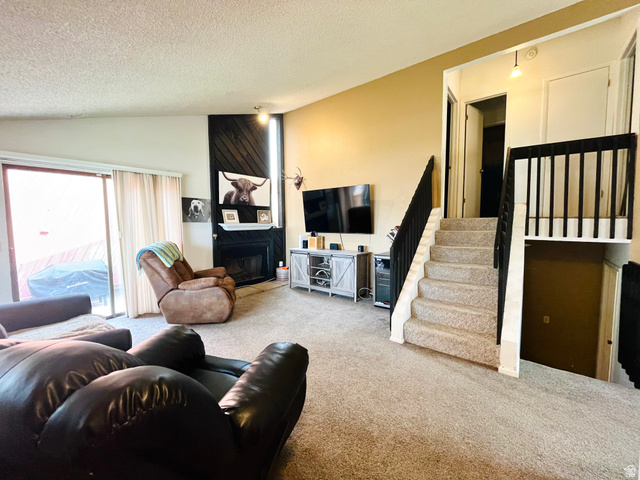 1450 Sagewood Road, Unit 16 Price, UT 84501 - Photo 2 of 15 Beautiful formal living room offering vaulted ceilings, sliding glass door, and a warm gas fireplace.
