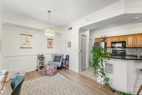 a kitchen with stainless steel appliances granite countertop a refrigerator a sink and white cabinets